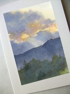 a watercolor painting of mountains and clouds