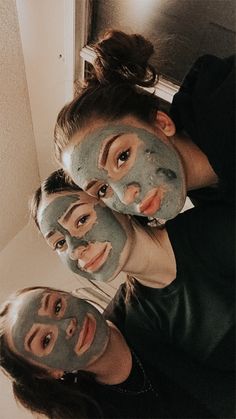 three people with facial masks on their faces