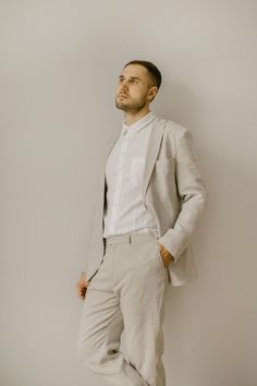 Our simple wedding suit consists of three components which are handcrafted from 100% finest softened Baltic linen: linen jacket, linen pants, linen shirt. Linen jacket comes in a slim/regular fit. It features three pockets, two-button closure, long sleeves. The jacket has a versatile classic style. It can be used for various occasions or casual wear.  Handcrafted with a double linen layer.  Linen shirt - a true embodiment of minimalism and timeless elegance. It designed with a comfortable slim/r Beige Linen Suit For Wedding, Linen Wedding Suit With Suit Collar, Wedding Linen Sets With Notch Lapel, Wedding Linen Set With Notch Lapel, White Linen Semi-formal Suits, Tailored Linen Suit For Wedding, Beige Linen Wedding Suit, White Linen Wedding Blazer, Simple Wedding Suit