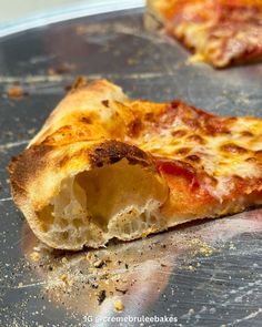 half eaten pizza sitting on top of a metal pan