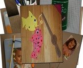 a group of different pictures on top of a wooden table next to pens and pencils