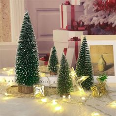 three small christmas trees sitting on top of a table