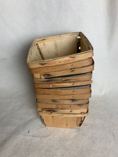 an old wooden crate is sitting on a white surface and has been used as a planter