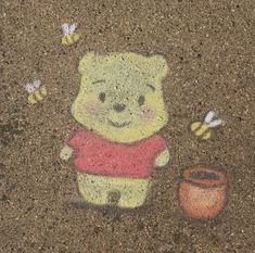 a drawing of winnie the pooh and honeybees is painted on the ground