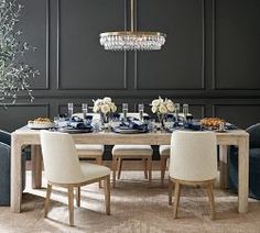 a dining room table with chairs and a chandelier