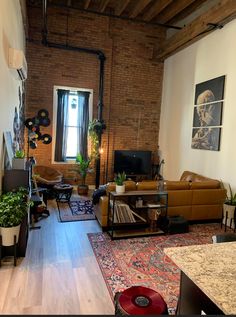 a living room filled with furniture and a flat screen tv sitting on top of a wooden floor