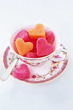 a cup filled with hearts sitting on top of a saucer