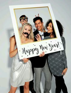 a group of people holding up a happy new year sign