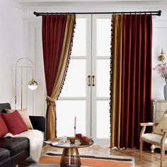 a living room filled with furniture and red curtains