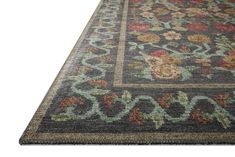 an area rug with flowers and vines on the bottom, in dark grey colors is shown against a white background