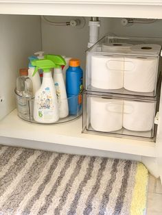 the shelves in the bathroom are filled with toilet paper and cleaning products, including hand sanitizers