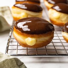 chocolate covered donuts cooling on a wire rack