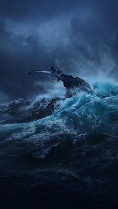 a large bird flying over the top of a wave in the ocean under a cloudy sky