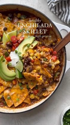 an enchilada skillet with tortilla chips and avocado