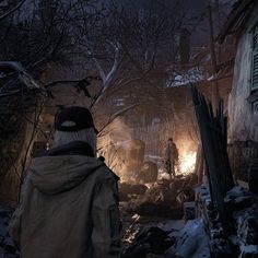 a man standing in front of a fire