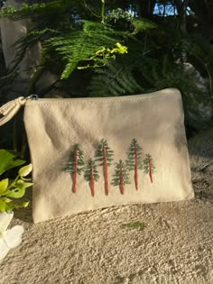 an embroidered pouch with carrots on it