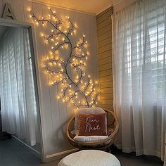 a chair and ottoman in a room with lights on the wall