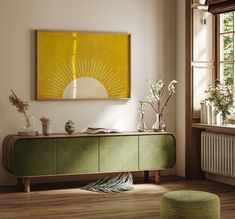 an empty room with a green cabinet and white flowers in vases on the table