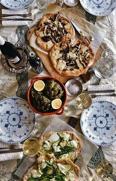 a table topped with plates and bowls filled with food