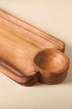 a wooden cutting board with a spoon on it