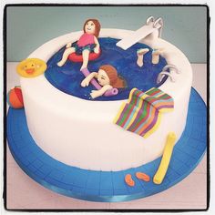 there is a cake that has been decorated with people in the water