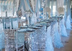 the tables are set with blue and silver decorations