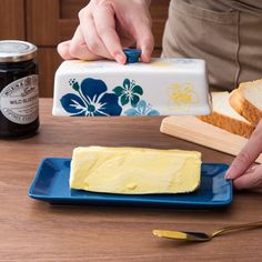 a person is spreading butter on some bread