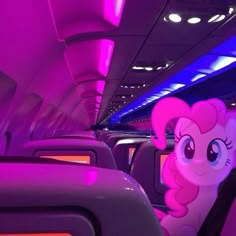 pinkie ponies are sitting in the aisle of an airplane with purple and blue lights