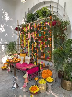 a room filled with lots of flowers and hanging decorations