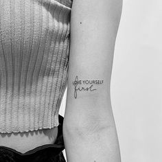 a woman with a tattoo on her arm that says, you're yourself here