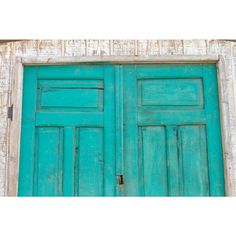 an old wooden door with blue paint on the front and side doors, painted teal green