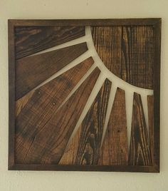 a piece of wood that has been made into a sunburst on the wall