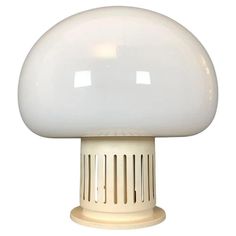 a white mushroom shaped light on top of a table