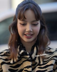 a young woman wearing a zebra print coat