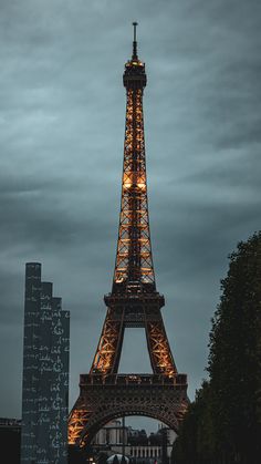 the eiffel tower is lit up at night