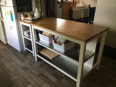 a kitchen island with two bins under it