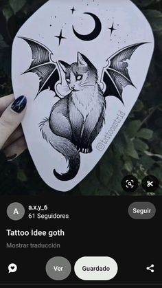 someone holding up a tattoo sticker with a cat on it's back and an image of a bat