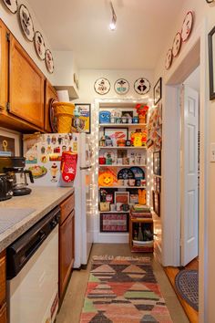 a kitchen with wooden cabinets and lots of plates on the wall next to the stove