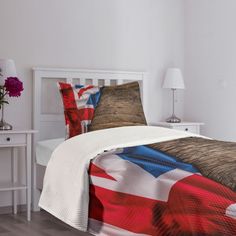 a bed with an american flag comforter and pillows