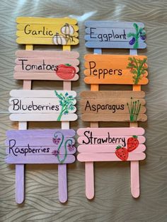 four popsicles with different types of vegetables painted on them and labeled in the words