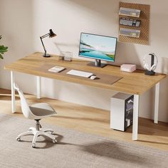 a desk with a computer monitor and keyboard on it in front of a wall mounted bookshelf