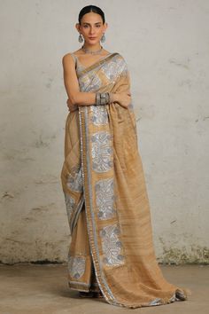 Indulge in the rich heritage of India with this stunning sari, showcasing a perfect blend of handwoven materials, intricate applique, and aari embroidery. This sari is adorned with a striking silver gota applique border. It comes with complementing plain unstitched blouse fabric. Festive Embroidered Cotton Silk Pre-draped Saree, Festive Pre-draped Embroidered Cotton Silk Saree, Cotton Silk Pre-draped Saree With Resham Embroidery For Festivals, Festive Embroidered Pre-draped Cotton Silk Saree, Embroidered Cotton Silk Pre-draped Saree For Navratri, Embroidered Tussar Silk Pre-draped Saree For Diwali, Transitional Embroidered Slub Silk Pre-draped Saree, Semi-stitched Slub Silk Saree With Resham Embroidery, Semi-stitched Embroidered Pre-draped Saree In Tussar Silk