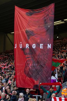 a large red banner in the stands at a soccer game