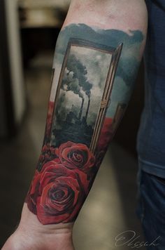 a person with a tattoo on their arm that has red roses in front of an open window