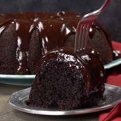 a piece of chocolate bundt cake on a plate with a fork