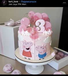 a peppa pig birthday cake with balloons on top