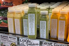 bottles of green goddess juice on display in a grocery store