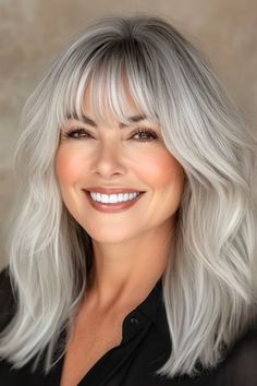 Save this pin for the best medium-length hairstyles for women over 50 with bangs. This silver lob is all about embracing texture and letting your natural hair color shine. The textured layers within the cut give the style movement, and the bangs frame your features. Side Swept Hair, Long Shag Hairstyles, Shaggy Long Hair, Layered Curls, Amazing Hairstyles, Shag Hairstyles, Natural Movement