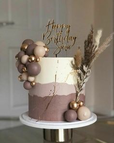 a birthday cake decorated with pink and gold decorations