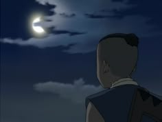 the man is looking at the moon in the sky